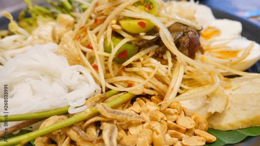 Som tum or papaya salad on dark table background. Thai food concept 
