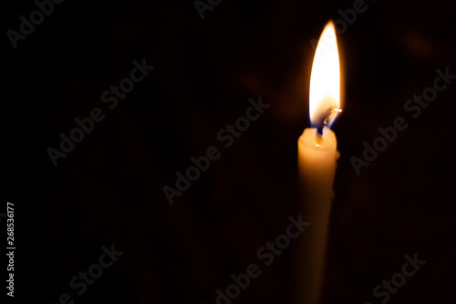 Closeup on Candle light in the dark. Abstract of creative light and hope on dark background 