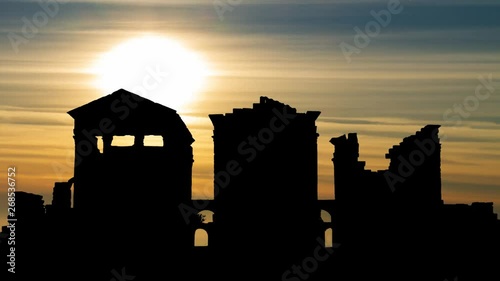Sbeitla Archaeological Site with Ruins of Sufetula at Sunset, Silhouette the Best Preserved Roman Forum Temples in Tunisia photo