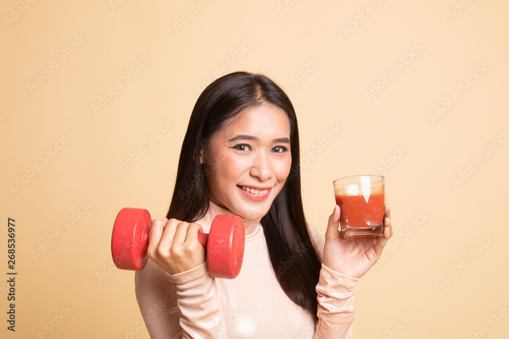 Healthy Asian woman with dumbbell and tomato juice. Healthy Asian woman with dumbbell and tomato juice.