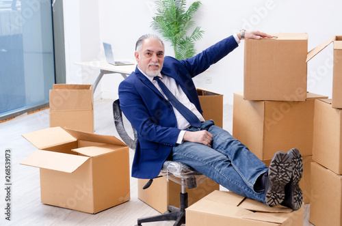 Aged businessman moving to new workplace 