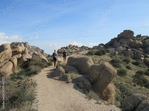 View of a trail with hikers on the path to Tom's Thumb in the McDowell Mountains in the Sonoran desert near Scottsdale, Arizona 