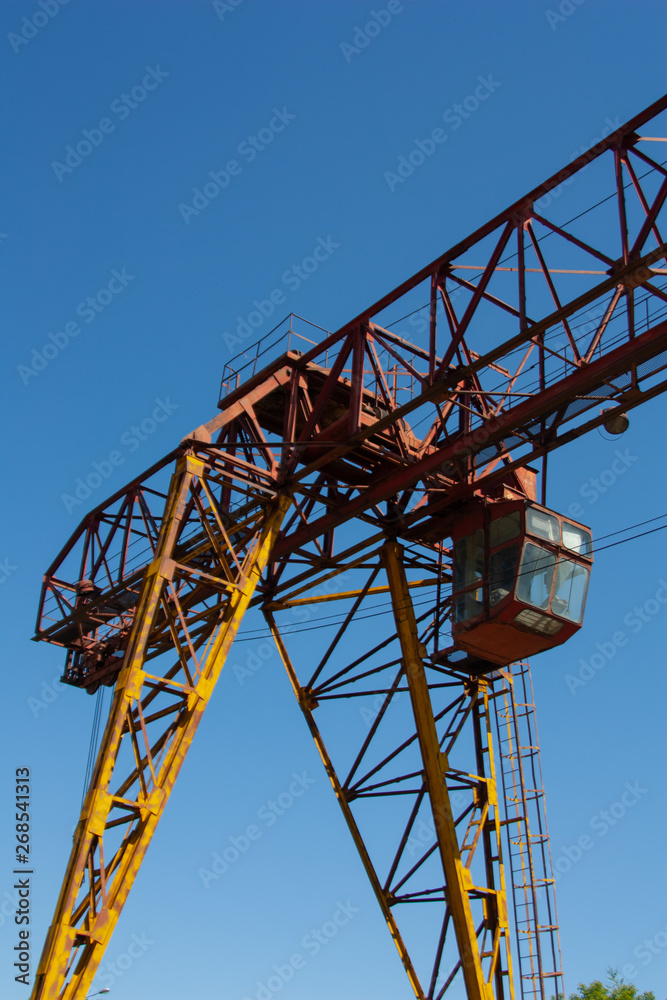 Old rusty overhead crane. Industrial construction