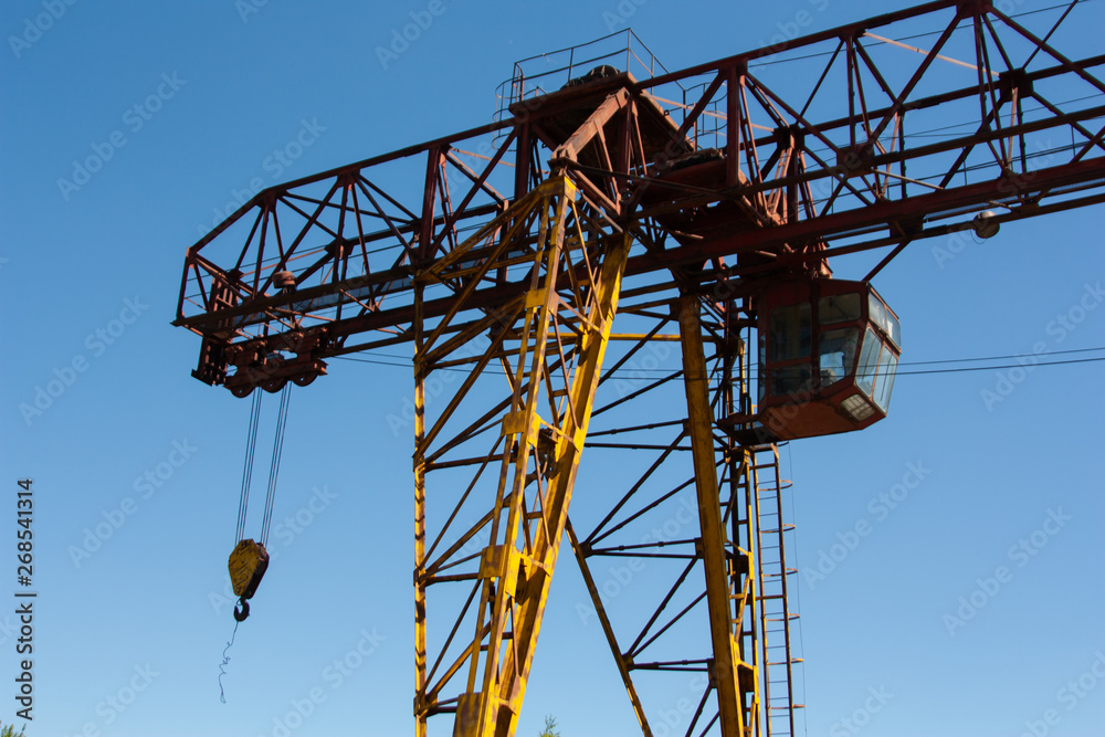 Old rusty overhead crane. Industrial construction
