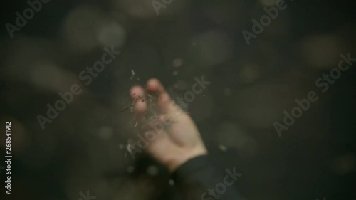 Black Tea shot in super slow motion with tea leaves falling towards camera. Black Backgorund. Alexa Plus Camera