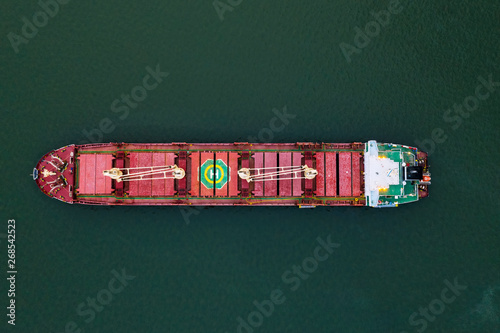 Shipping cargo to harbor by ship. Water transport International. Aerial view
