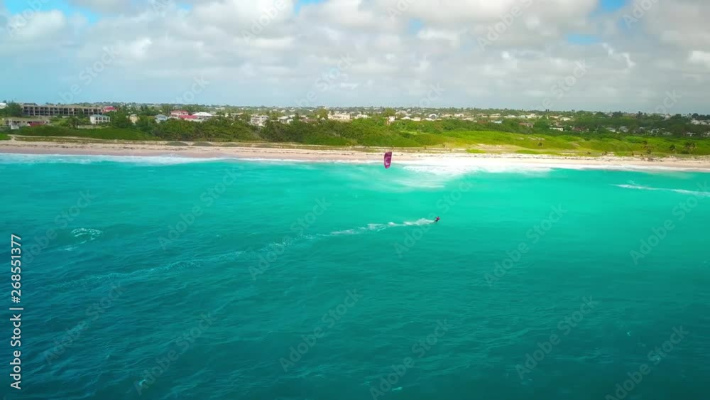 Aerial view, kite surfer approaching the coastline of Barbados. Aerial view, kite surfer approaching the coastline of Barbados.