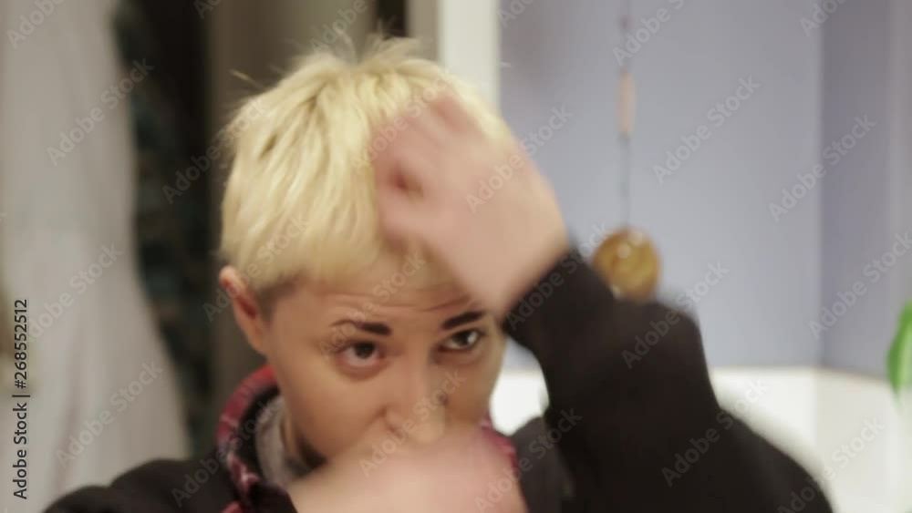 A person playing and fiddling with their hair. A person playing and fiddling with their hair.