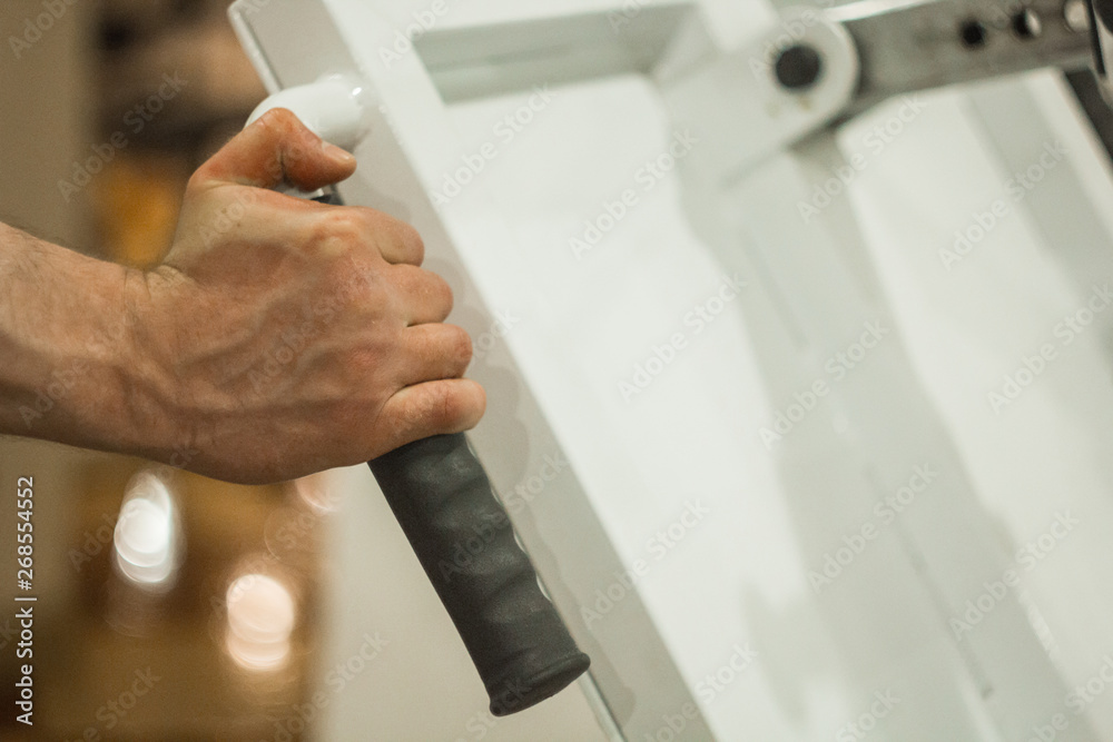 The athlete holds his hands on the hilt of the training machine in the training center. training tools in the gym close-up