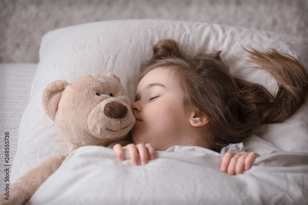 Little cute girl in bed with toy Little cute girl in bed with toy