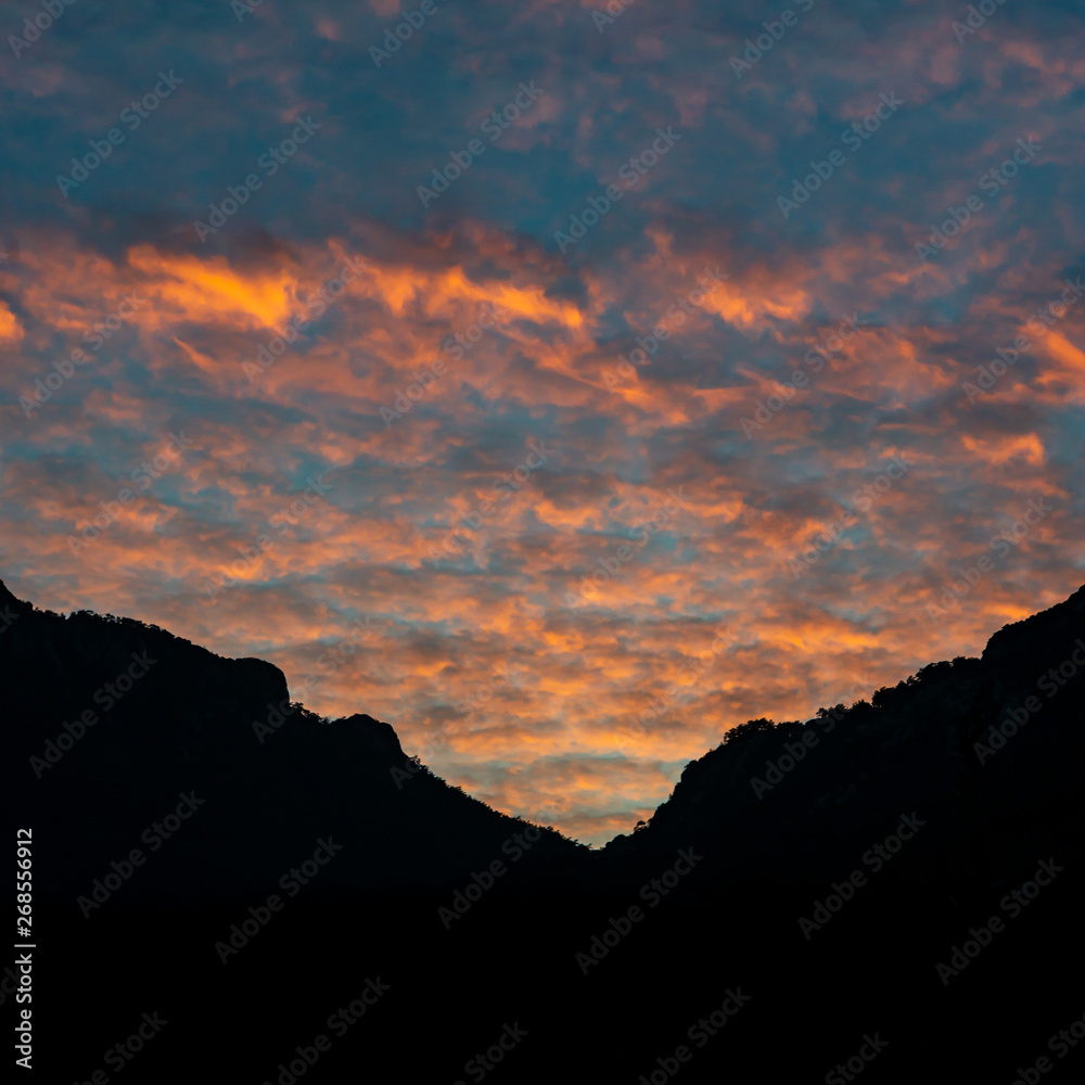Altocumulus clouds and sunset sky landscape on silhouette mountains. Marmaris, Turkey.