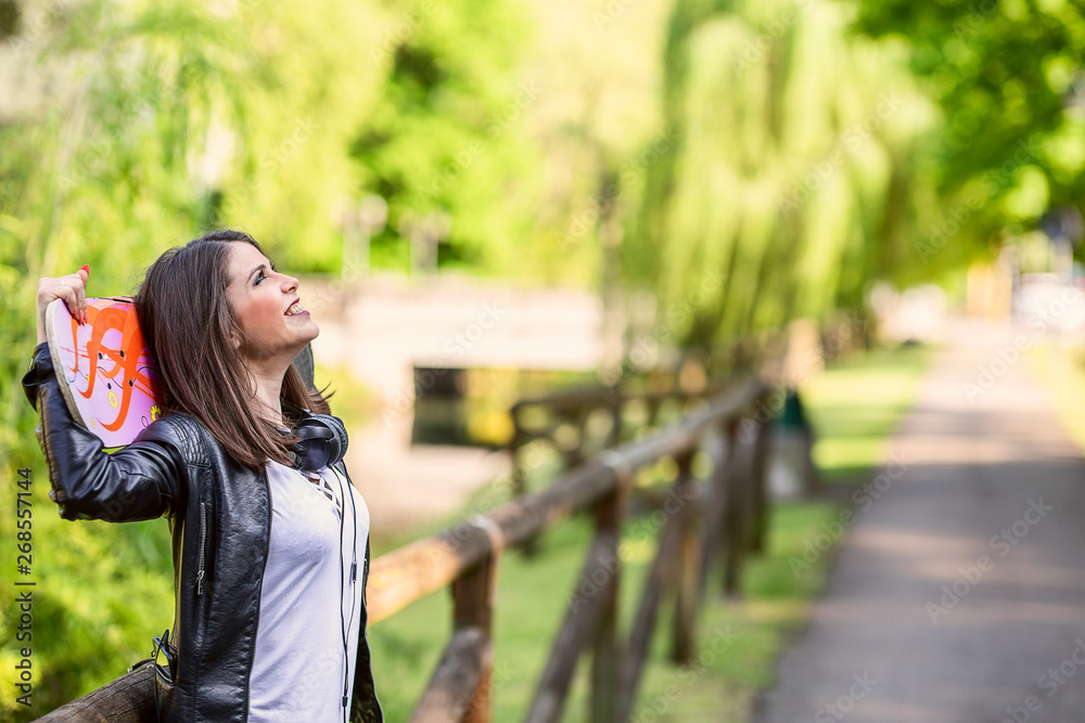 Naklejka premium Young woman with his longboard