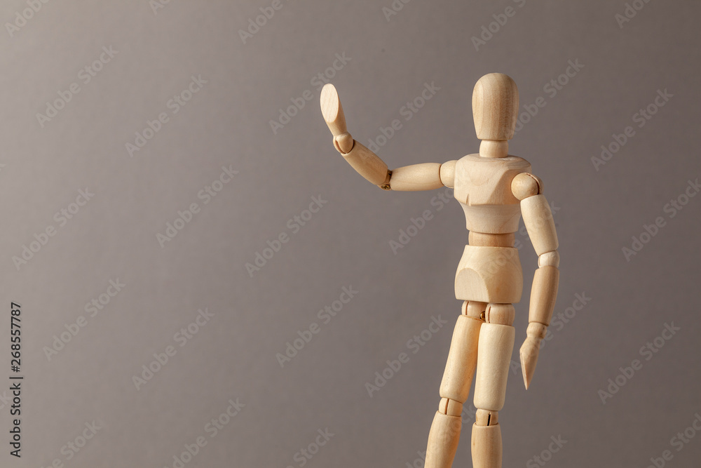 Man raised his hand up symbolizing the STOP signal on a gray background. Copy space for text. Man raised his hand up symbolizing the STOP signal on a gray background. Copy space for text.