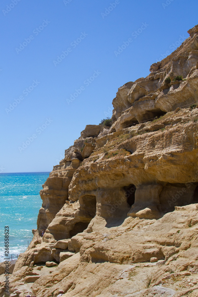 Early Christian tombs, carved out in the sandstone rocks near Matala on Crete