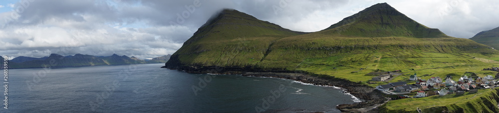 Faeroe Islands with beautiful nature, green grasslands, sea, rocks and breathtaking landscape