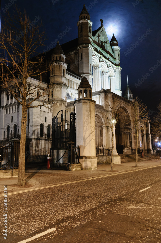 St Anne's Cathedral, Belfast, at night, with a full moon behind