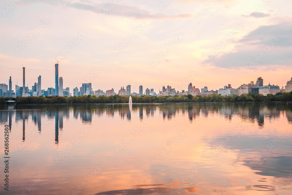 Sunset View of Manhattan skyline from Jacqueline Kennedy Onassis Reservoir in Central Park, reflection in water