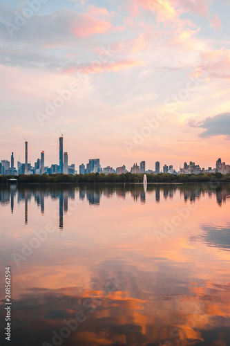 Sunset View of Manhattan skyline from Jacqueline Kennedy Onassis Reservoir in Central Park  reflection in water