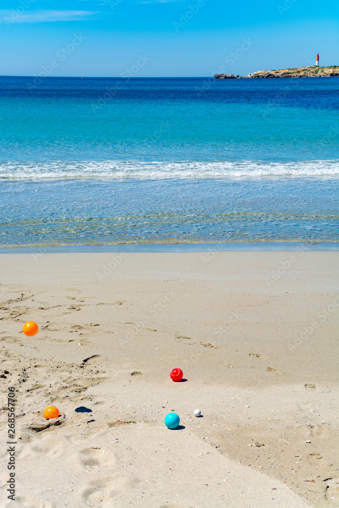 Obraz premium Crystal clear blue Mediterranean sea water on St.Croix Martigues beach and kids beach toys, Provence, France