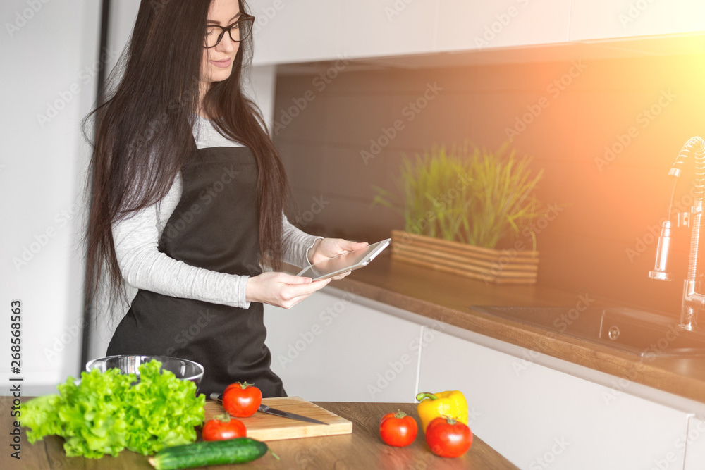 Young trendy woman cooking healthy food in the morning Young trendy woman cooking healthy food in the morning
