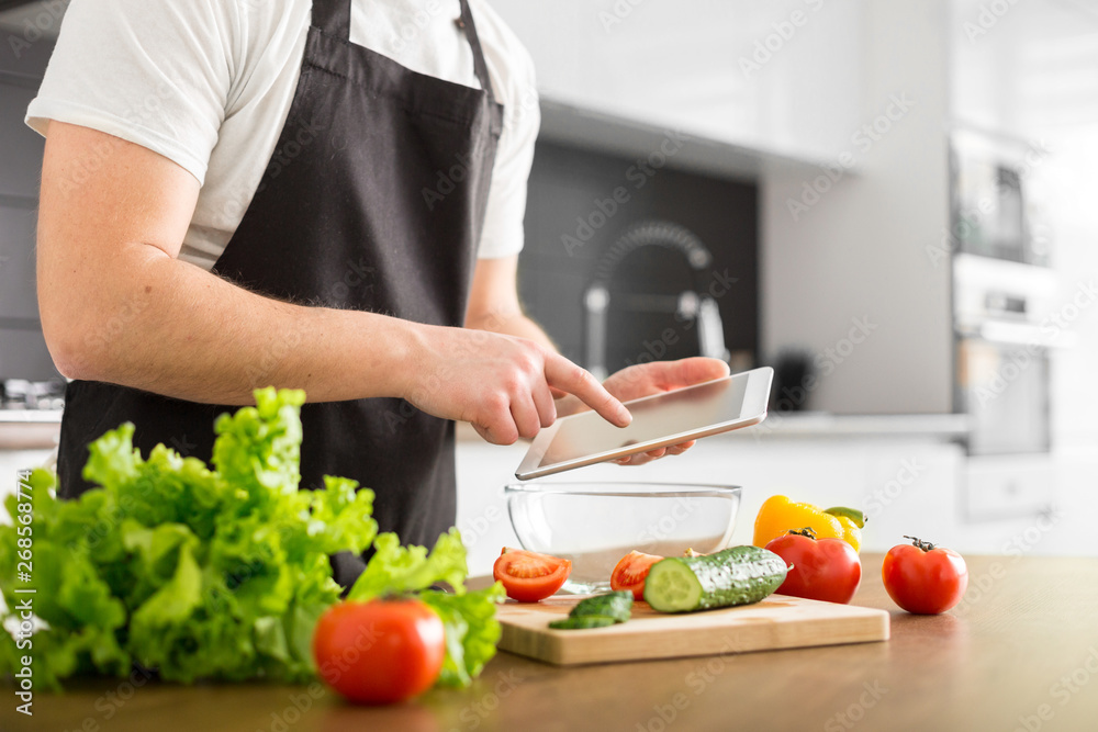 Young trendy man cooking healthy food in the morning Young trendy man cooking healthy food in the morning