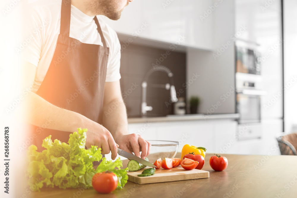 Young trendy man cooking healthy food in the morning Young trendy man cooking healthy food in the morning