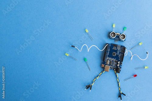 Back to school concept. A metal robot and an electronic board that can be programmed. Robotics and electronics. DIY robotics. STEM and STEAM education for kids. Free space for text.