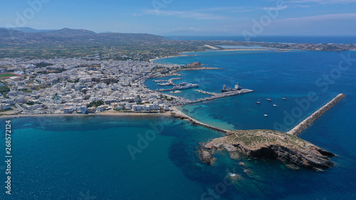 Fototapeta Naklejka Na Ścianę i Meble -  Aerial drone panoramic view of iconic and unique Temple of Apollon or Portara (Gate) with breathtaking views to port - town and castle of Naxos island and the Aegean blue sea, Cyclades, Greece