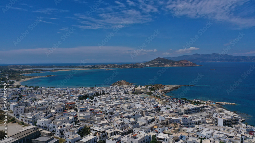 Aerial drone photo of iconic port of Naxos island featuring uphill castle and beautiful Temple of Apollon or Gate, Cyclades, Greece