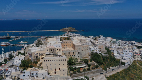 Aerial drone photo of iconic port of Naxos island featuring uphill castle and beautiful Temple of Apollon or Gate, Cyclades, Greece © aerial-drone