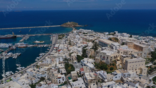 Fototapeta Naklejka Na Ścianę i Meble -  Aerial drone photo of iconic chora, main town of Naxos island featuring beautiful uphill castle views to the Aegean deep blue sea and Temple of Apollon at the background, Cyclades, Greece