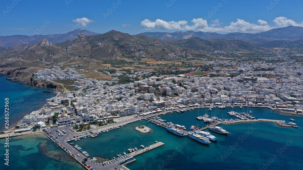 Aerial drone photo of iconic port of Naxos island featuring uphill castle and beautiful Temple of Apollon or Gate, Cyclades, Greece