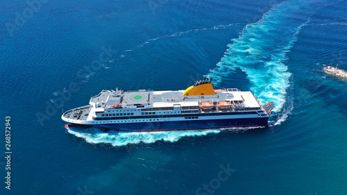 Aerial drone top view photo of high speed passenger ferry arriving at port of Mykonos island, Cyclades, Aegean sea, Greece photo