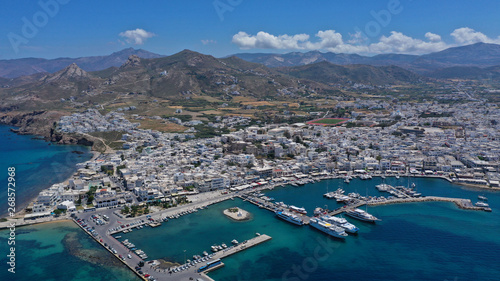 Aerial drone photo of iconic port of Naxos island featuring uphill castle and beautiful Temple of Apollon or Gate, Cyclades, Greece