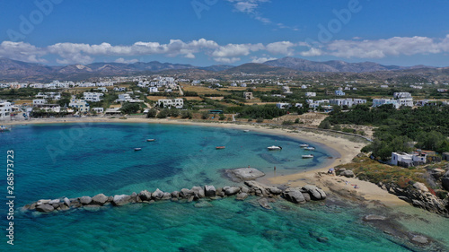 Aerial drone photo of breathtaking turquoise round sandy beach and small village and small seaside picturesque chapel of Agia Anna, Naxos island, Cyclades, Greece