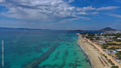 Fototapeta Naklejka Na Ścianę i Meble -  Aerial drone top view photo of breathtaking turquoise sandy beach of Plaka with sun beds and umbrellas, Naxos island, Cyclades, Greece