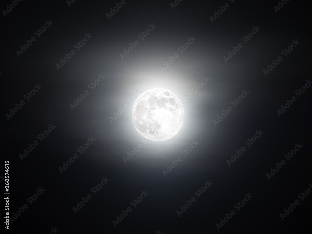 Foggy sky with the bright full moon glowing in the dark Foggy sky with the bright full moon glowing in the dark