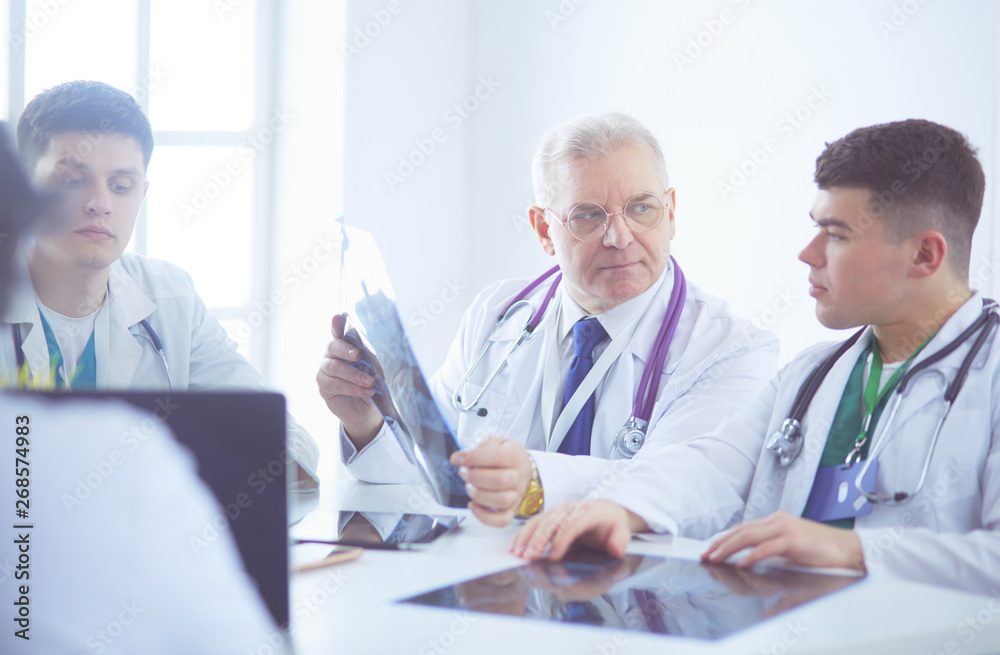 Medical team sitting and discussing at table Medical team sitting and discussing at table