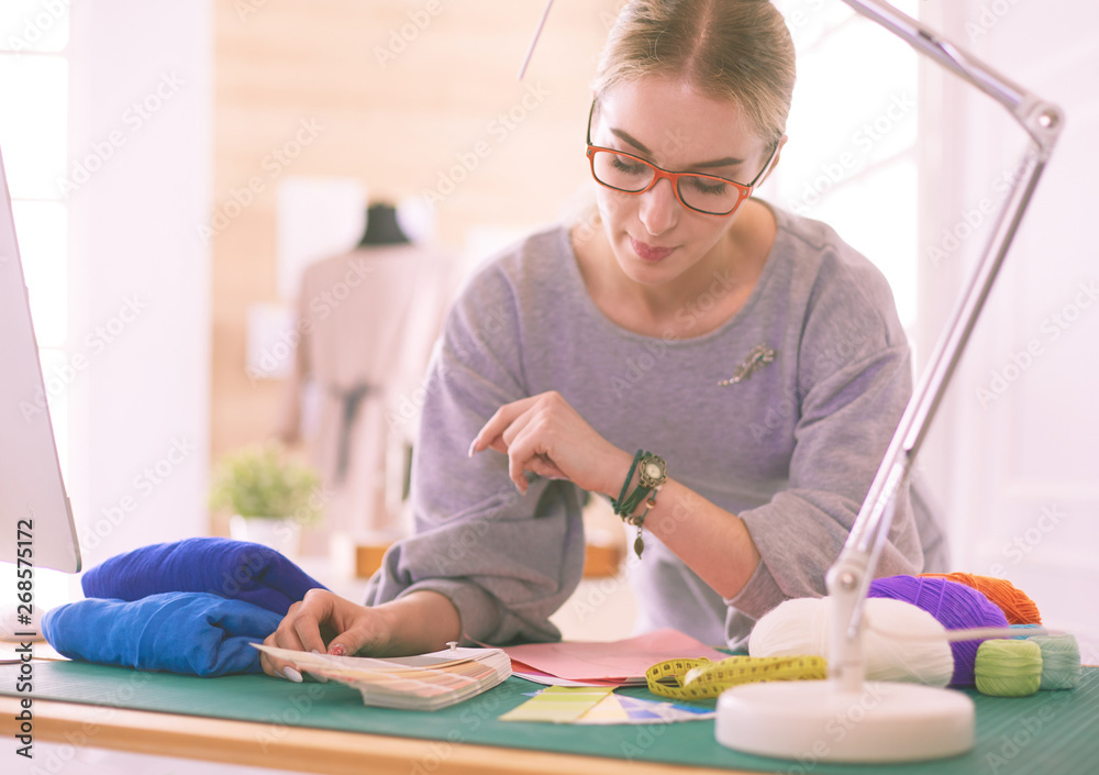 Woman American fashion designer working in atelier Woman American fashion designer working in atelier