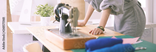 Fashion designer woman sewing with sewing machine