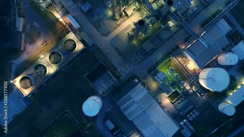 Aerial view night light oil terminal is industrial facility for storage of oil and petrochemical. oil manufacturing products ready for transport and business transportation. power electric plant.
