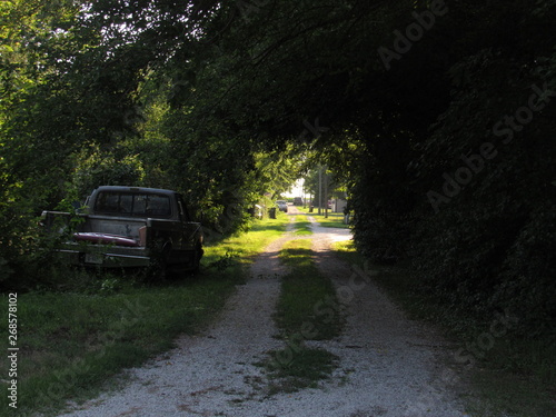 Abandoned car along an unused road
