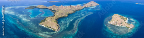 Photography Seen from a bird's eye view, idyllic islands are surrounded by healthy coral reefs in Komodo National Park, Indonesia