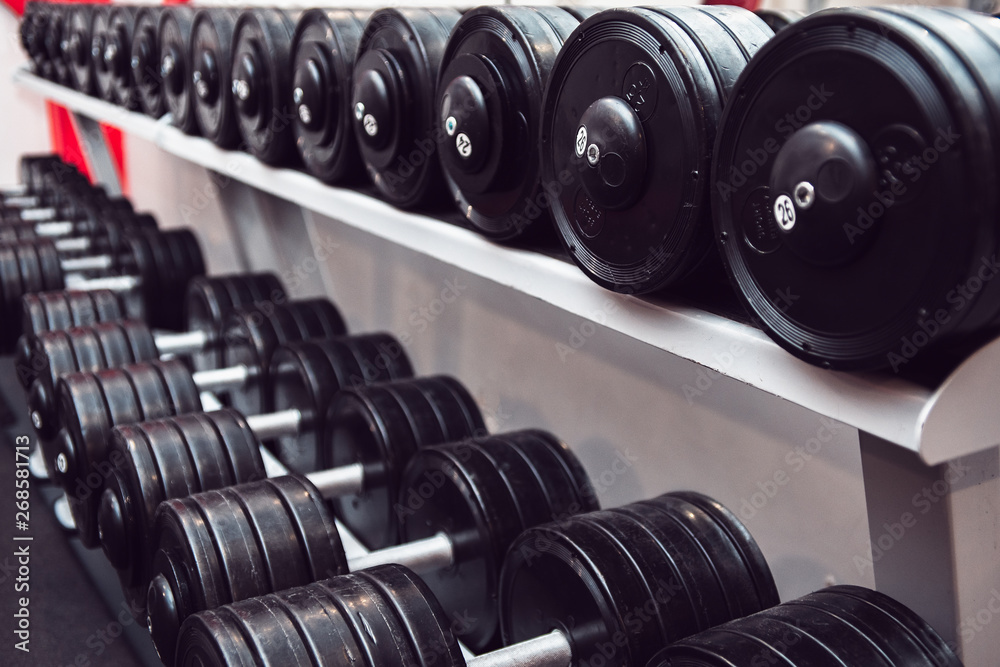 Gym and dumbbell weight training equipment on sport. Healthy life and gym exercise equipments and sports concept. Сopy space