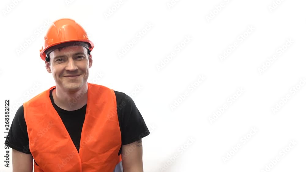 Man in working uniform on white background Portrait of young male in bright orange protective hardhat and vest looking at camera on white background Man in working uniform on white background Portrait of young male in bright orange protective hardhat and vest looking at camera on white background