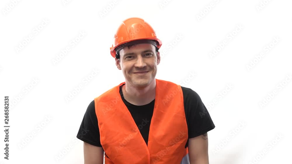 Man in working uniform on white background Portrait of young male in bright orange protective hardhat and vest looking at camera on white background Man in working uniform on white background Portrait of young male in bright orange protective hardhat and vest looking at camera on white background