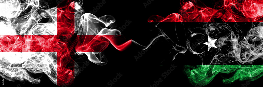 English vs Libya, Libyan smoky mystic flags placed side by side. Thick colored silky smokes flag of England and Libya, Libyan. English vs Libya, Libyan smoky mystic flags placed side by side. Thick colored silky smokes flag of England and Libya, Libyan.