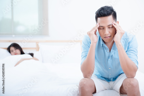 Photography Husband unhappy and disappointed in the erectile dysfunction during sex while his wife sleeping on the bed