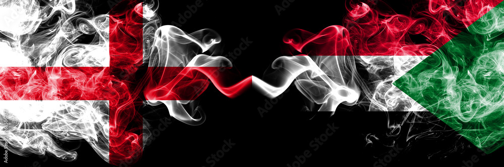 Fototapeta premium English vs Sudan, Sudanese smoky mystic flags placed side by side. Thick colored silky smokes flag of England and Sudan, Sudanese.