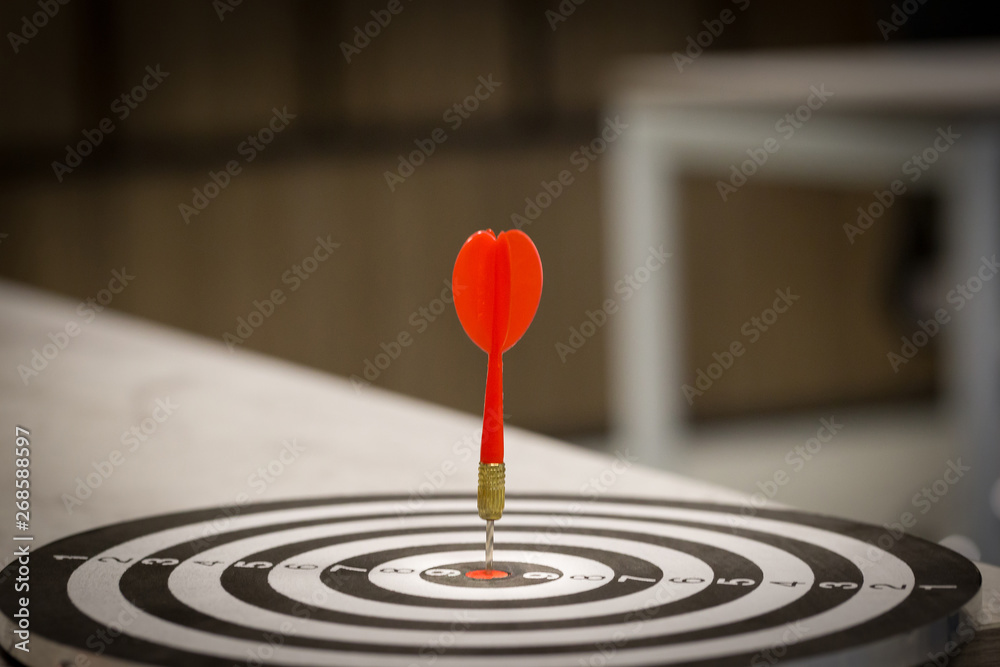 Red dart target arrow hitting on bullseye with,Target marketing and business success concept - Image Red dart target arrow hitting on bullseye with,Target marketing and business success concept - Image